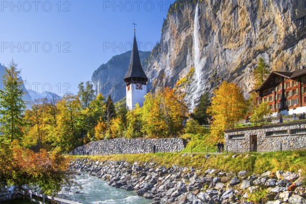 Village church with Staubbach waterfall in autumn, Lauterbrunnen, Bernese Oberland, Canton of Bern,
