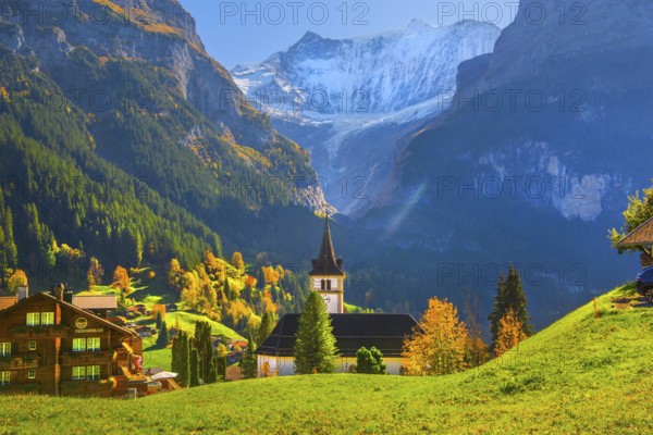 Village church in the town center with fieschörner 4049m in autumn, Grindelwald, Lütschinental,