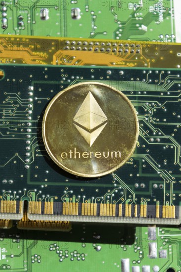 Golden ethereum coin lying on computer motherboard, cryptocurrency investing concept Prague, Czech