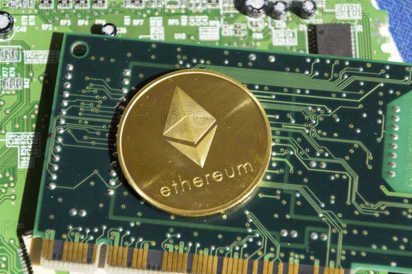 Golden ethereum coin lying on computer motherboard, cryptocurrency investing concept Prague, Czech