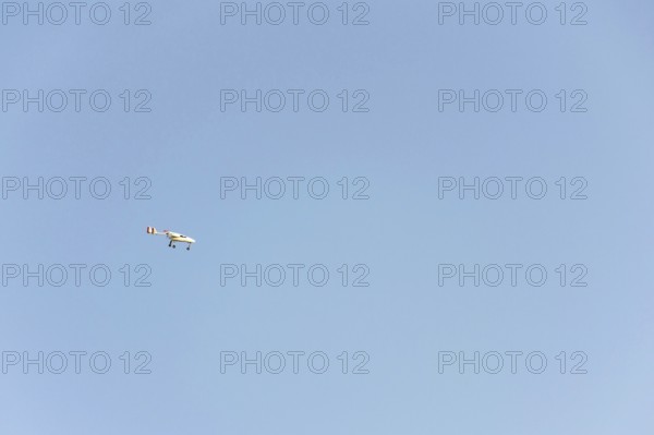 Unmanned aerial vehicle surveillance drone with light and camera flying, sunny summer day, drone