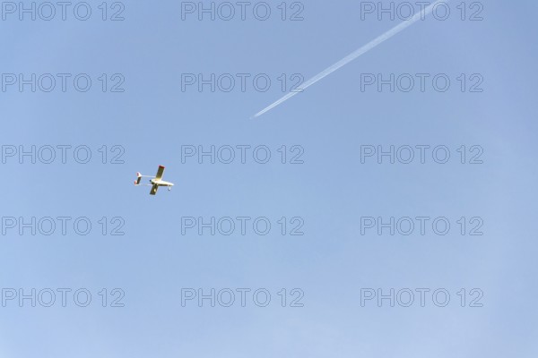 Unmanned aerial vehicle surveillance drone with light and camera flying, sunny summer day, drone