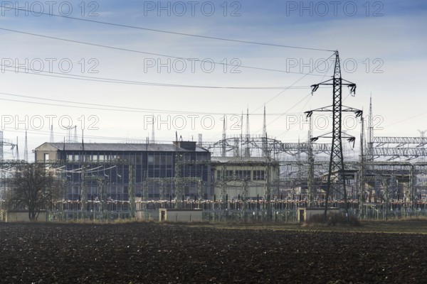 Distribution power station with electricity pylons and dramatic cloudy sky background Prague Czech