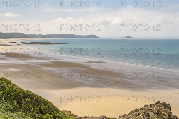 A panoramic view from the Sentier Littoral cliff path shows the vast, shallow bay of Erquy and its