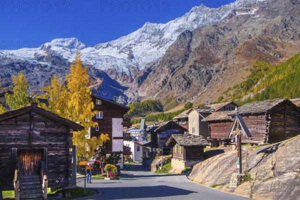 Typical granaries on the outskirts of the village with Alphubel 4206m and Mischabel group 4545m in