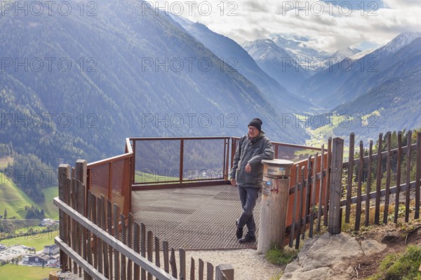 Hikers on a viewing platform near the suspension bridge on the Sunnenseit'n-Weg hiking trail, in