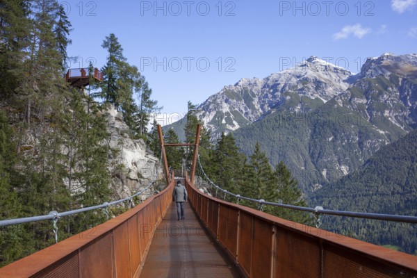 Mount Serles with suspension bridge on the Sunnenseit'n-Weg hiking trail, in autumn, Neustift im