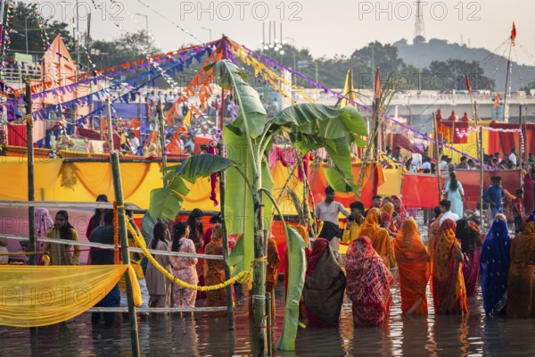 Hindu devotees gather on the banks of the Brahmaputra River to offer prayers to the Sun God on the