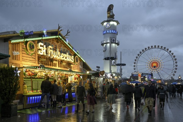 Oktoberfest visitors with umbrellas, rainy meadows, Löwenbräuturm, Ferris wheel, Munich, Bavaria,