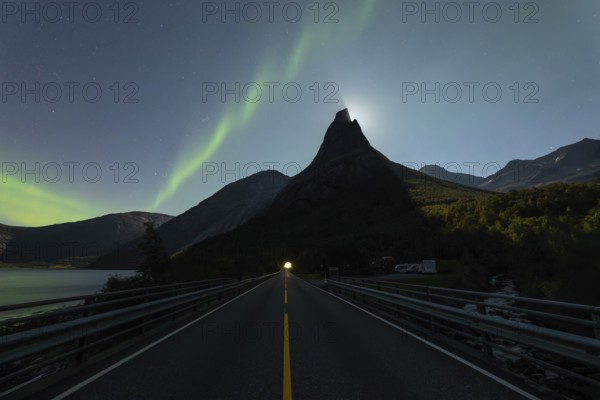 National mountain of Norway, Stetind in the Nordland under auroras and a full moon behind the