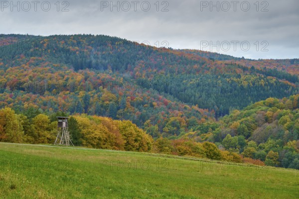 Autumn landscape with hunting pulpit, colorful forests and hills under cloudy sky, autumn,