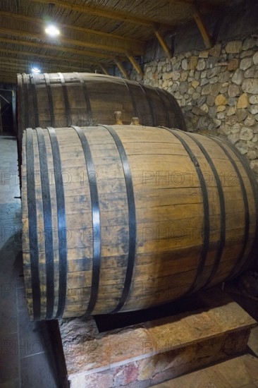 Two large wooden barrels in a cellar with rustic stone walls, Hin Areni Winery, Areni Village,