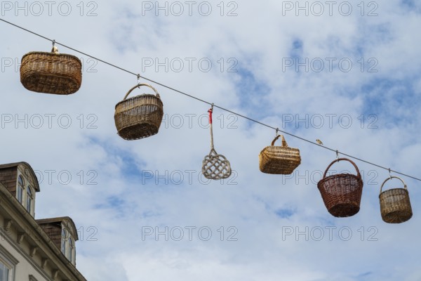 Woven baskets hang over the pedestrian zone in front of the sky, Deutsche Korbstadt, Lichtenfels,