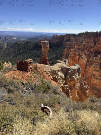Sublime red stone pillars surrounded by green vegetation and sweeping views across the countryside,