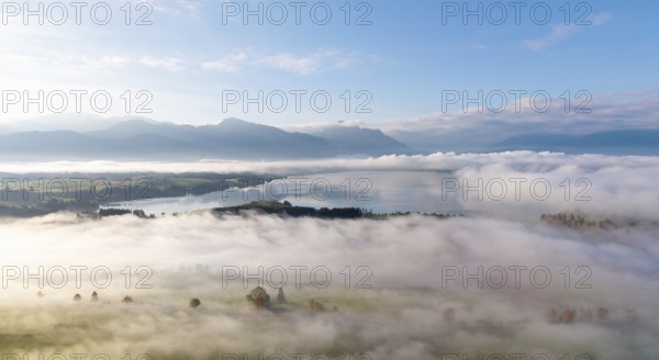 Morning fog covers a vast landscape with Lake Forggensee, near Roßhaupten, Ostallgäu, Allgäu,