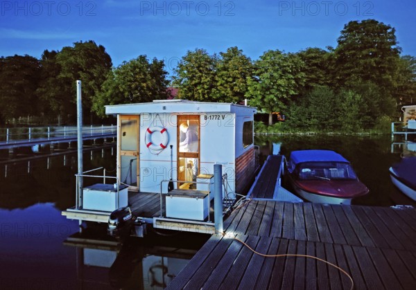 Houseboat at dusk at Marina Lindow (Mark), Gudelacksee, Stechlin-Ruppiner Land nature park Park,