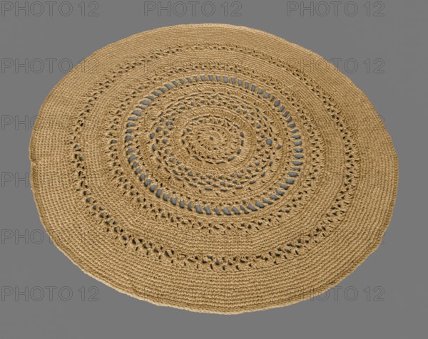 Round crocheted rug on a gray background