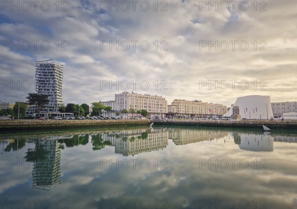 Beautiful waterfront scene in Le Havre, France at sunset. Buildings are perfectly reflected in the