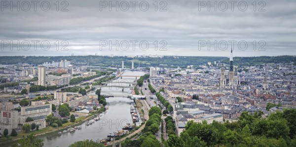 Panoramic view of the Rouen city in France, with the winding Seine river and numerous bridges.