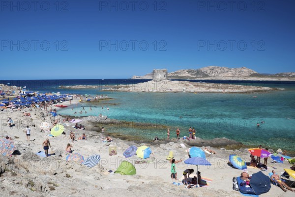 STINTINO, ITALY - AUGUST 21, 2017 - Unidentified people in the sun on the famous La Pelosa Beach on