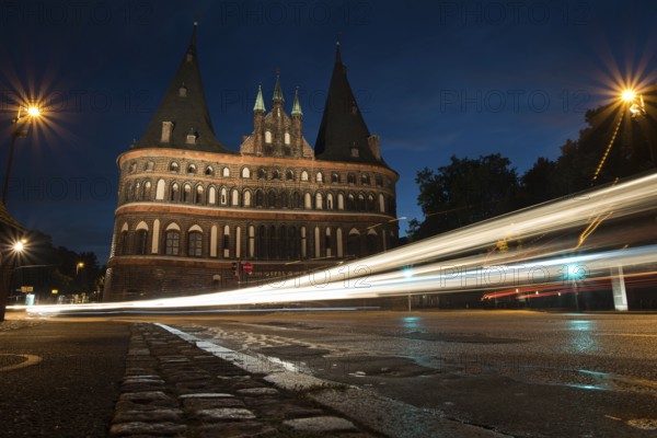 LUBECK, GERMANY - AUGUST 3, 2016: Holstentor Gate during twilight. Lubeck is the 2nd largest city