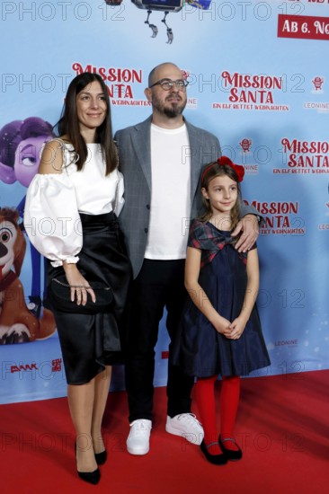 Director Damjan Mitrevski with woman and daughter at a special screening of MISSION SANTA - AN ELF