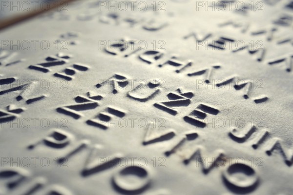 Word rose in Czech language embossed writing letters for blind people used before Braille writing