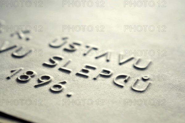 Word blind in Czech language embossed writing letters for blind people used before Braille writing