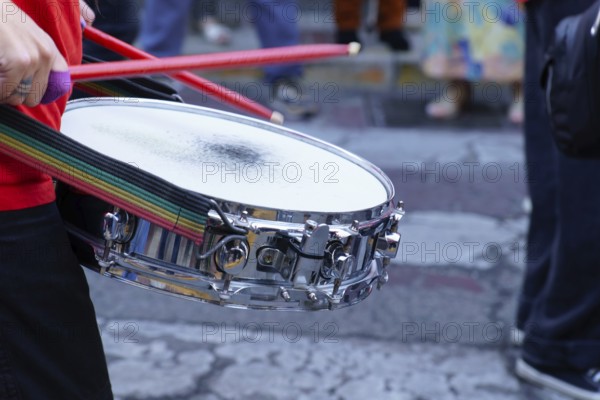 Ronda, malaga, spain Drummer playing snare drum with red drumsticks during a vibrant street parade,
