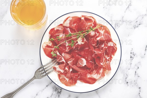 Plate with sliced cured meat, pork neck, prosciutto coppa, Italian delicacy