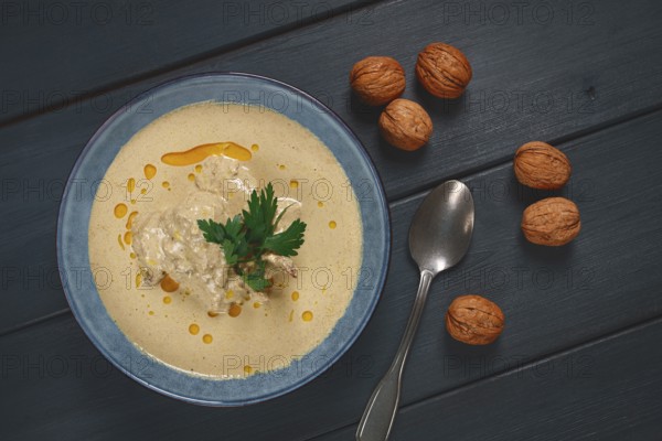 Satsivi, Georgian dish, chicken in nut sauce, cold appetizer, on a wooden table, no people,