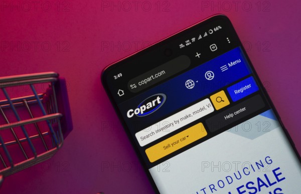 Dhaka, Bangladesh- 23 June 2025: A smartphone displaying the Copart website with a shopping cart is