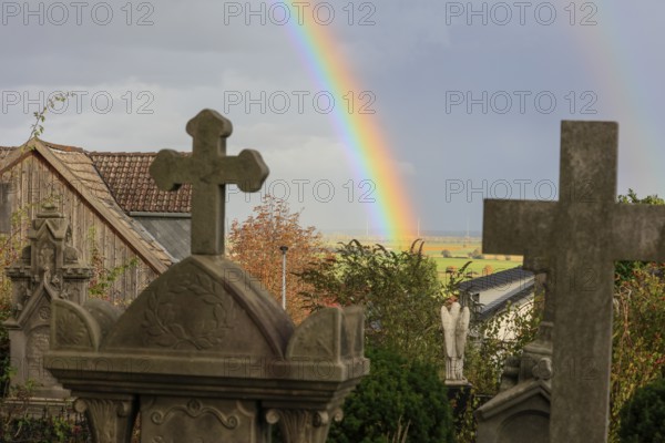 Rainbow over the heritage-protected cemetery near St. Marien Church, Lüdersen mountain village,