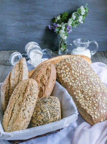 Freshly baked artisanal bread assortment displaying sourdough, multigrain, and seeded loaves and