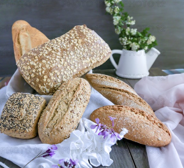 Various freshly baked artisanal bread loaves, including whole grain and sourdough, beautifully