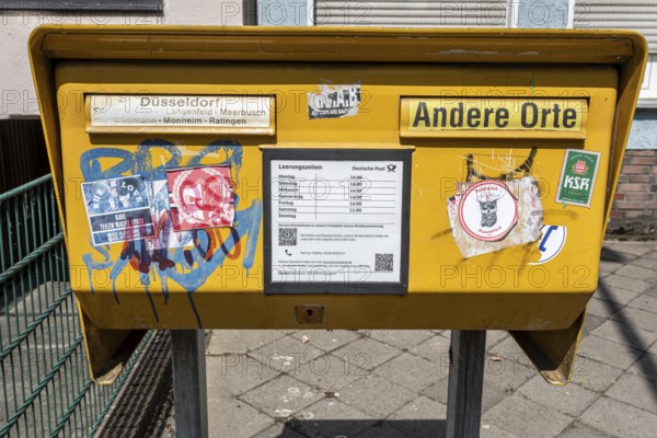 Painted and stickered post box in Mörsenbroich — Düsseldorf, North Rhine-Westphalia, Germany