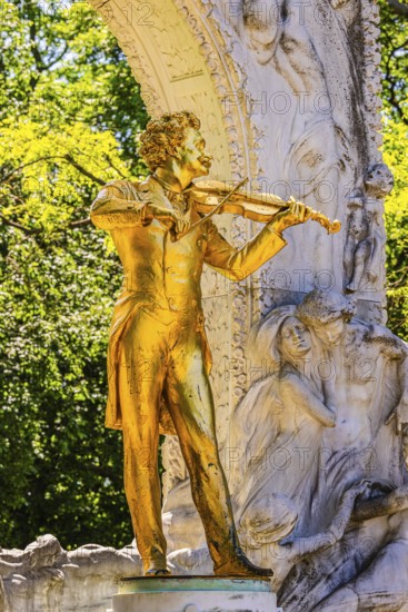 The gilded bronze statue of Johann Strauss, the Waltz King, memorial in the municipal park, Vienna,