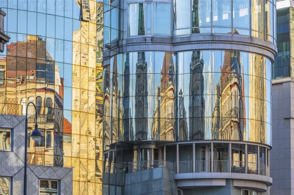 Historic buildings are reflected in the glass façade of the Haas House, Stephansplatz, Vienna,