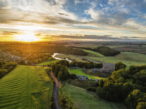 Sunset over Norham Castle and River Tweed from a drone, Norham, Northumberland, England, United