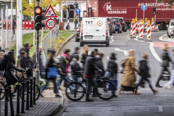 Pedestrians at Düsseldorf-Bilk train station, cross Friedrichstraße at a pedestrian crossing with