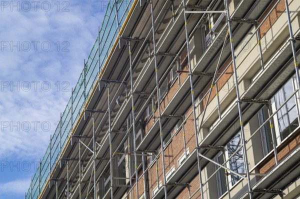 Borken, NRW, Germany, RBuilding renovation showing metal scaffolding and green safety netting