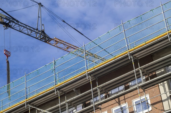 Borken, NRW, Germany, RBuilding undergoing renovation with metal scaffolding and safety netting