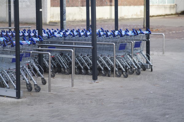 Borken, NRW, Germany, REmpty shopping carts neatly arranged in rows under a shelter in a parking