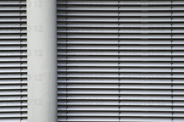 Borken, NRW, Germany, RModern building facade with horizontal lines from closed blinds and a