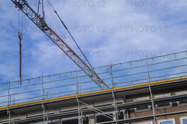 Borken, NRW, Germany, RConstruction crane and scaffolding against a blue sky, renovating a building