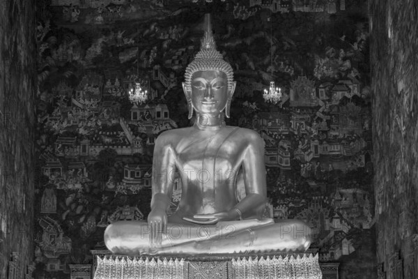 Golden Buddha statue, Phra Buddha Trilokachet surrounded by crystal chandeliers and exquisite wall