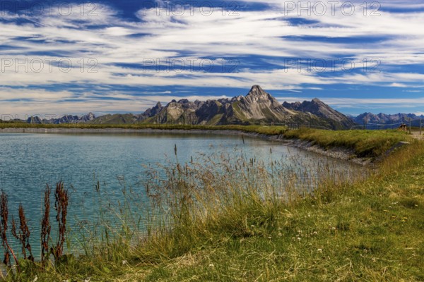 The panoramic lake at Saloberkopf with mountains in the background under a blue sky, Wart, Bregenz,