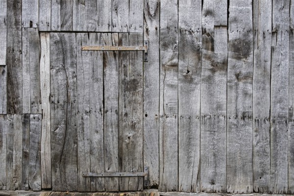 Wooden door with metal fittings in an old wooden barn, Borken-Weseke, Münsterland, North