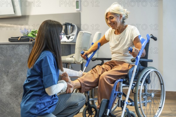 Nursing professional administering physical therapy to an elderly woman in a wheelchair, focusing