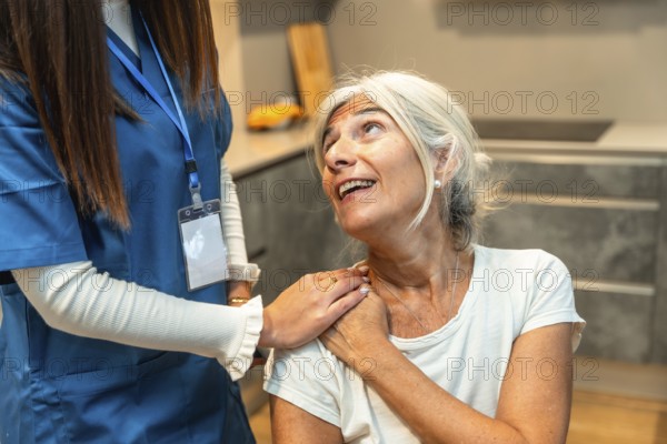 Caregiver gently supporting senior woman at home, offering compassionate medical assistance,